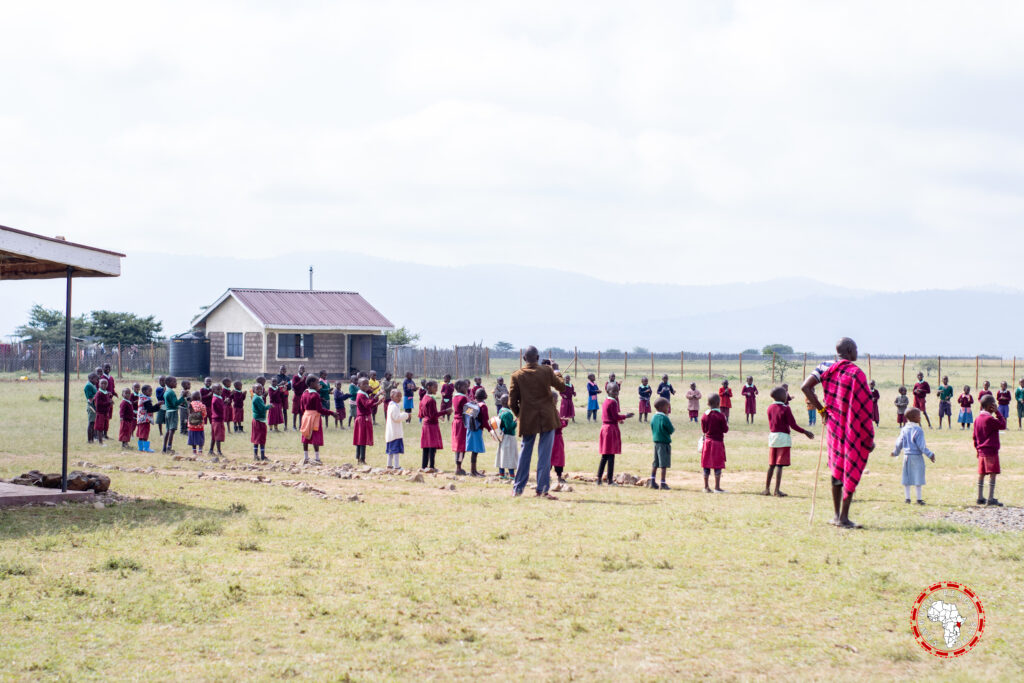 Children and Teachers playing in the field.